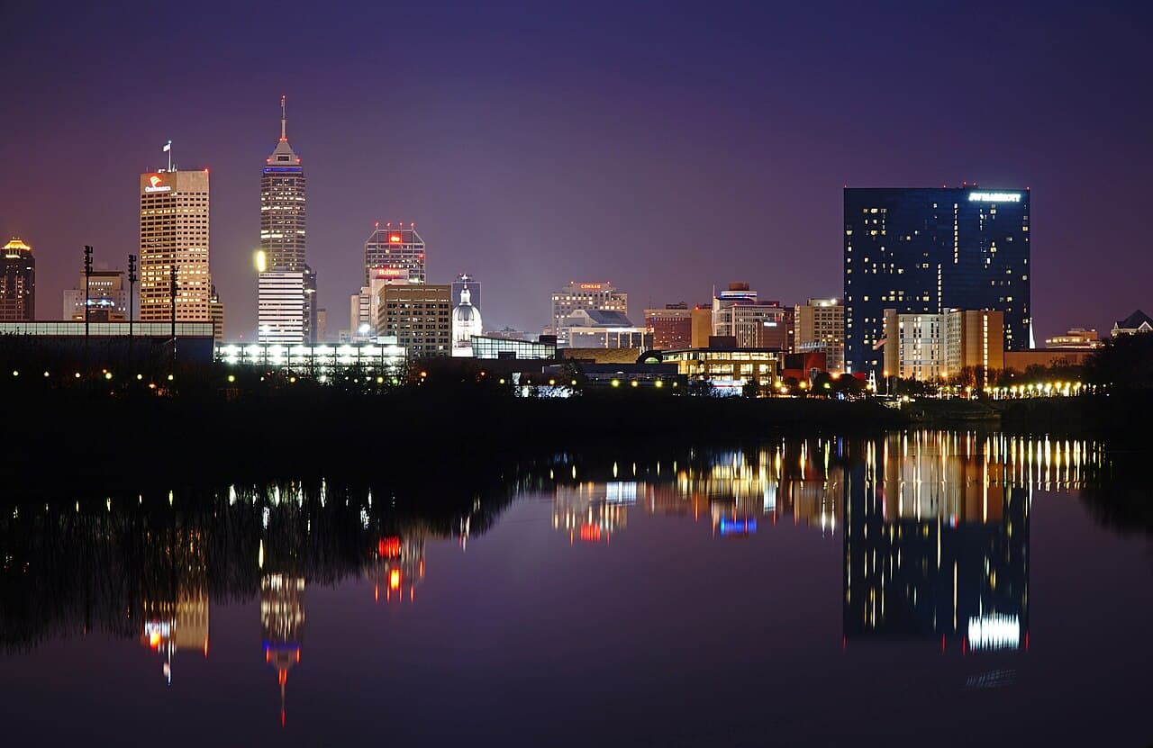 Downtown Indianapolis skyline reflected across the White River at night
